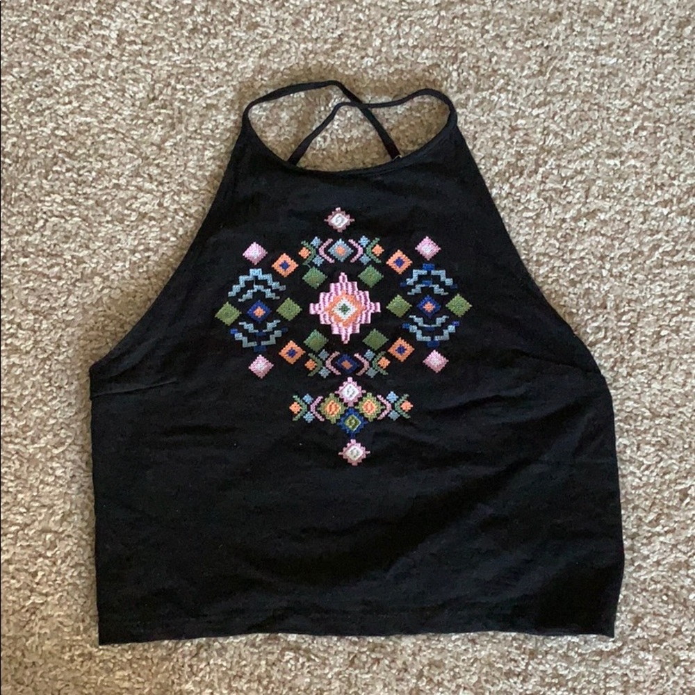 Halter crop top with embroidered geometric shapes.
